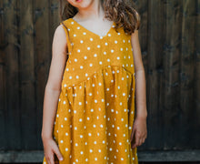 Modern girls dress sewing pattern featuring distinctive bodice seam lines