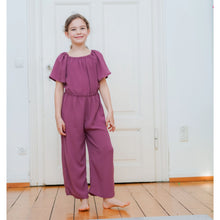 Wide leg jumpsuit sewing pattern for girls made with lightweight woven fabric